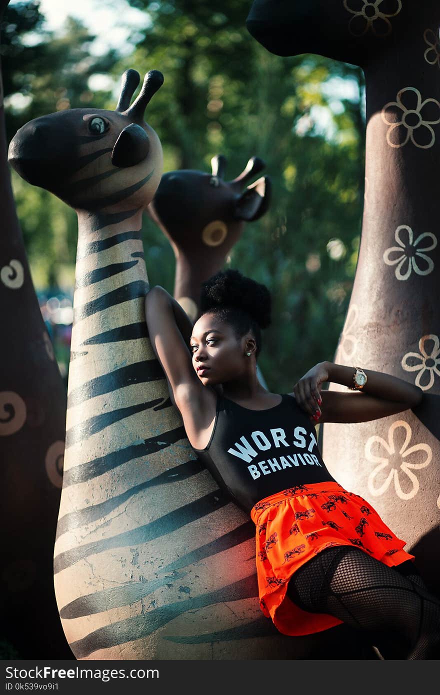 Woman Leaning on Zebra Statue