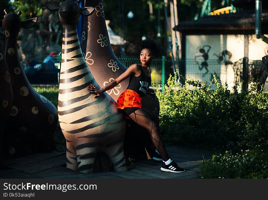 Photo of Woman Beside Zebra Statue