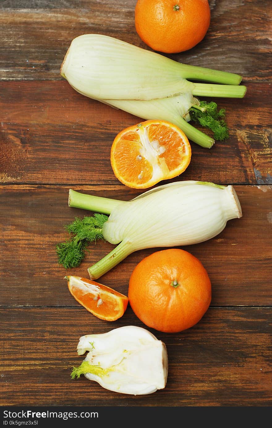 Fennel Vegetable Isolated. Fennel and Orange Citrus Fruit over Wooden Background. Healthy Vegetarian Food.