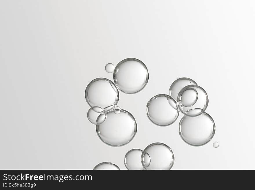 Beautiful light shiny water bubbles soars over a grey background. Beautiful light shiny water bubbles soars over a grey background.