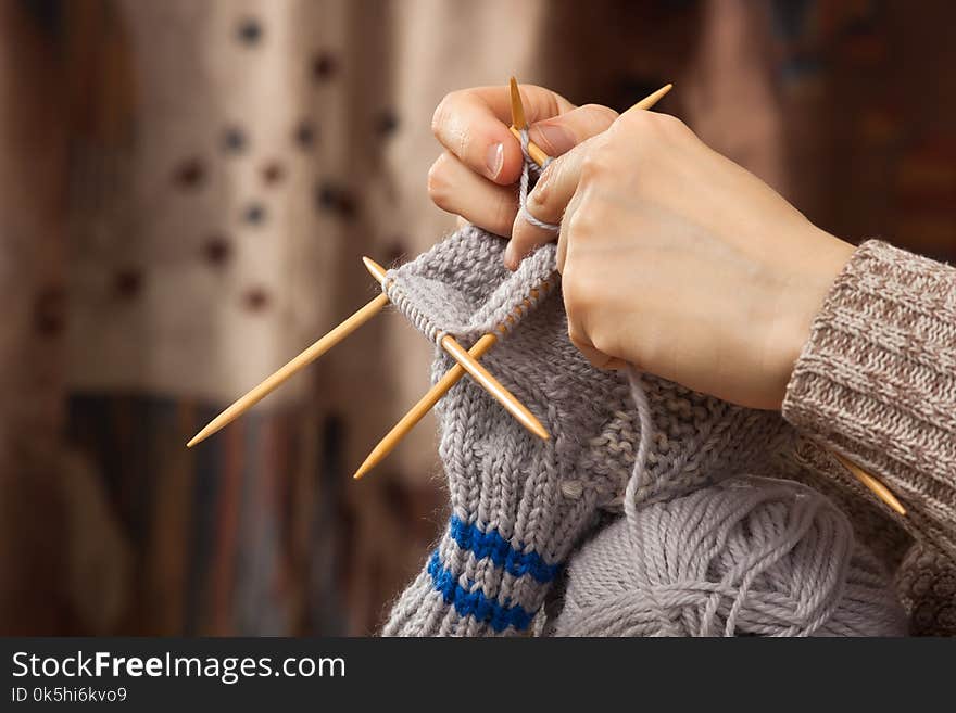 Hands of woman knitting a sock