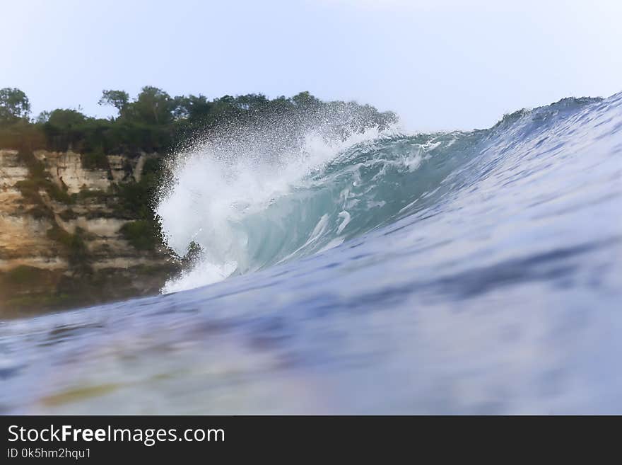 Ocean wave with mountain in background