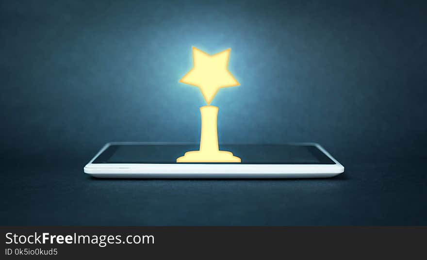 Golden Award on digital tablet. Success concept