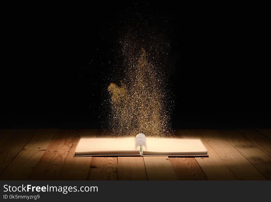 Magic book on wooden floor