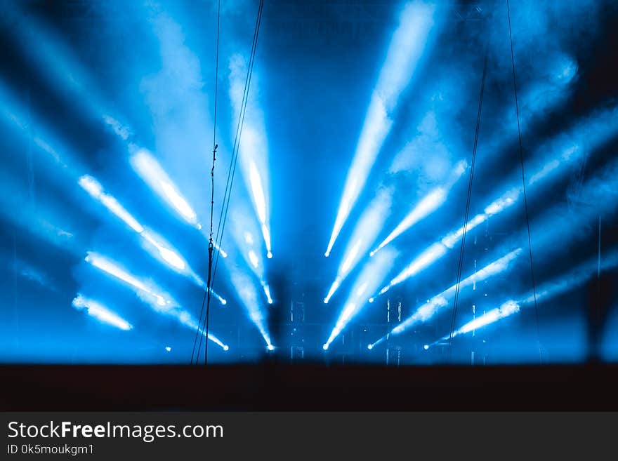 The light rays from the spotlight through the smoke. Lighting equipment on the ceiling. The stage of a theatre or night club. Show or performance. The light rays from the spotlight through the smoke. Lighting equipment on the ceiling. The stage of a theatre or night club. Show or performance.