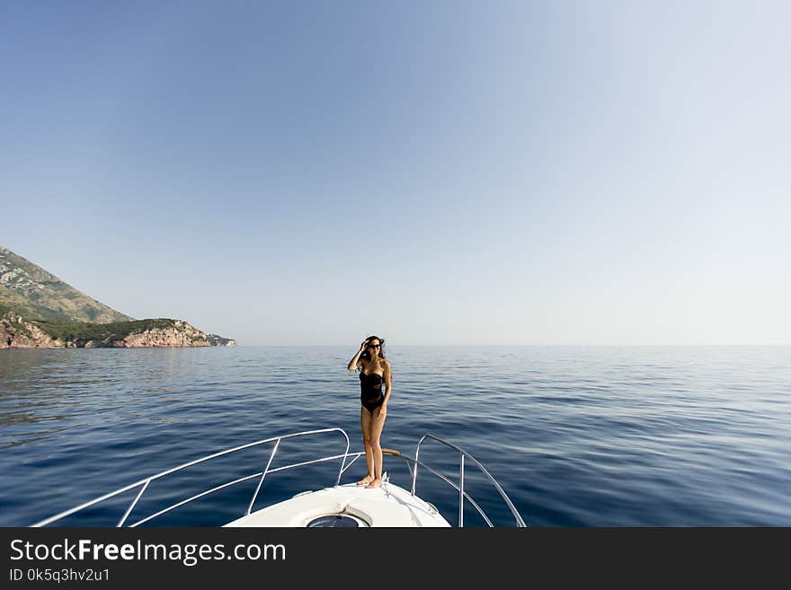 Pretty young woman relaxing on the yacht