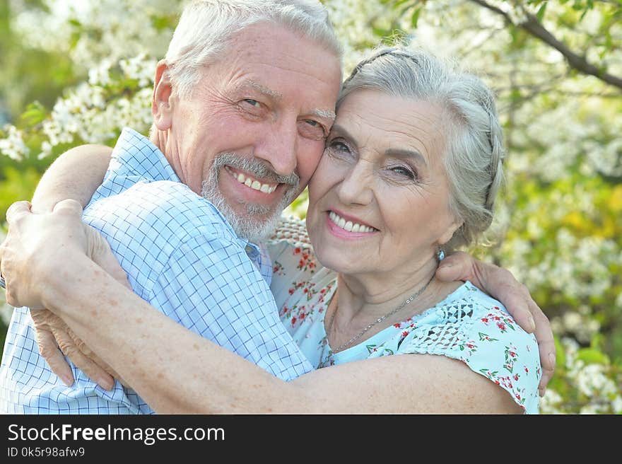 Happy couple hugging in spring blooming garden. Happy couple hugging in spring blooming garden