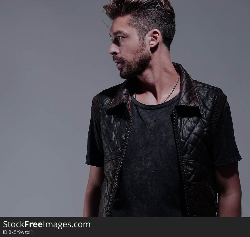 Portrait Of A Pensive Handsome Man Over Gray Background