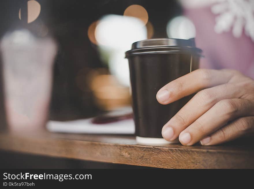 Close-up Of Young Man Holding Coffee To Take Away At Early Morning At Cafe.