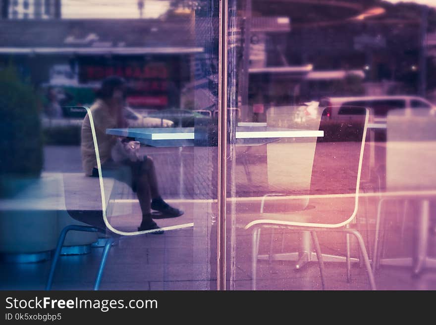 Empty Table With Chairs In A Shop Beside Glass Window.