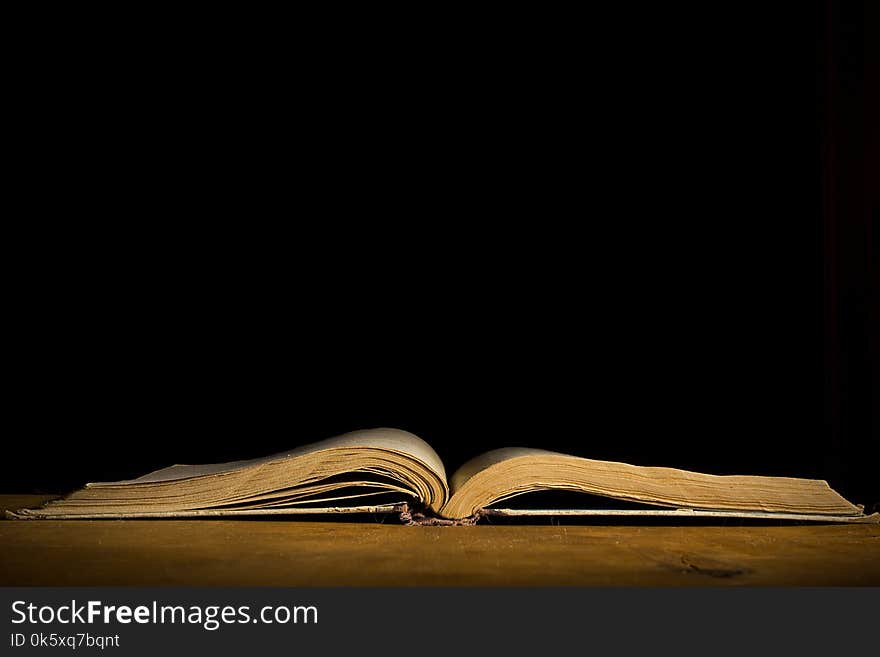 Open old book on a wooden table