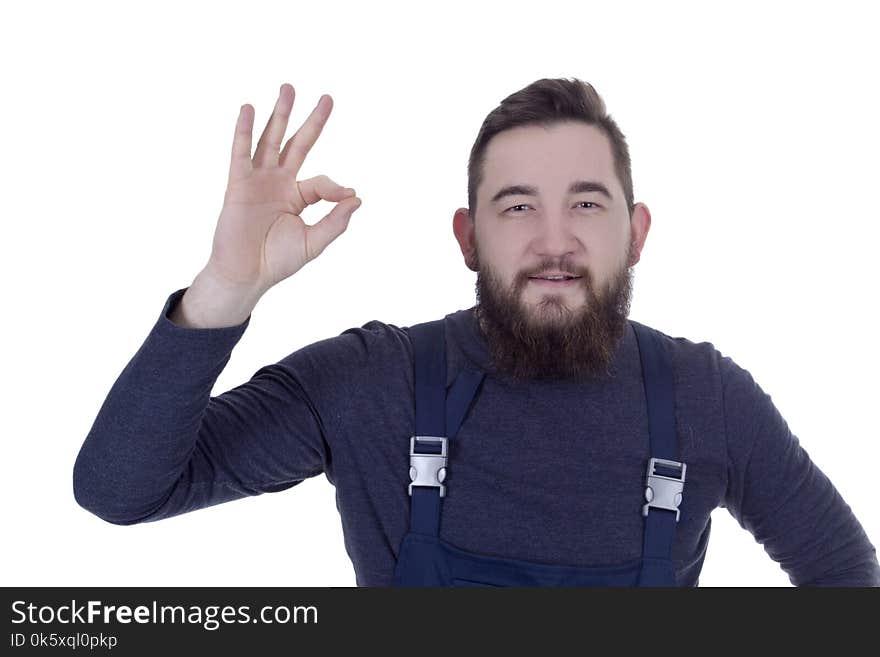 Young man with a beard in overalls