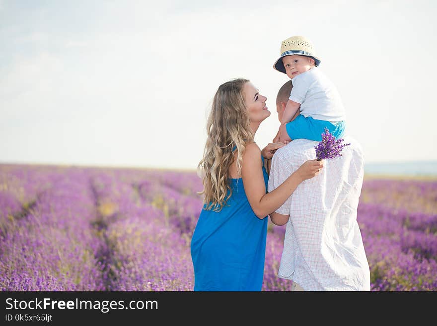 Mom, Dad and their little son are walking in a lavender field. Life in Provence. Mom, Dad and their little son are walking in a lavender field. Life in Provence