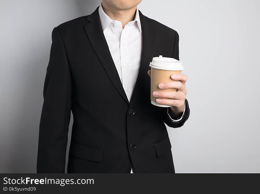 Business man holding a paper cup