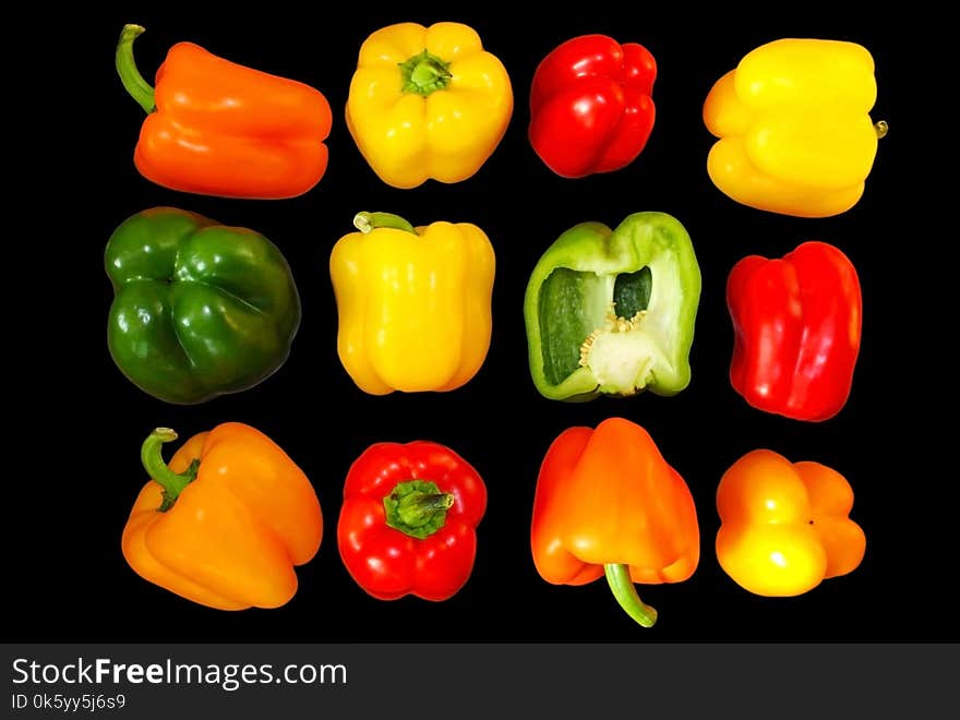 Rainbow pepper with multiple colors green, yellow, red, orange colors isolated on a black background. Rainbow peppers or chili are common vegetables for sale in the supermarket. Rainbow pepper with multiple colors green, yellow, red, orange colors isolated on a black background. Rainbow peppers or chili are common vegetables for sale in the supermarket.