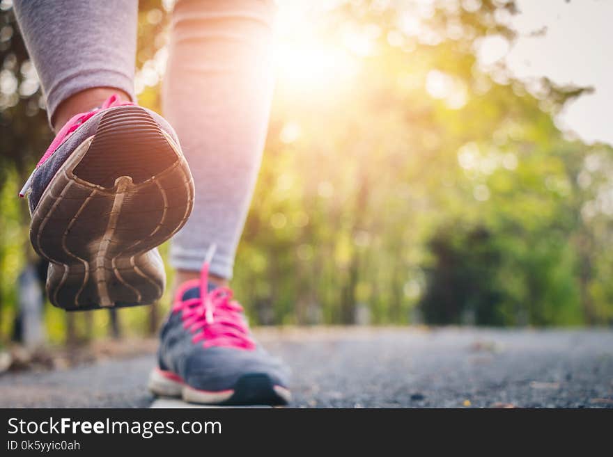 Women runner feet on road in workout wellness.