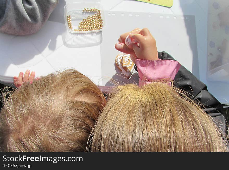 A child with mother decorate a gingerbread