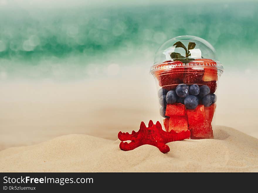 Plastic Cup Full Of Fresh Cut Fruits And Berries