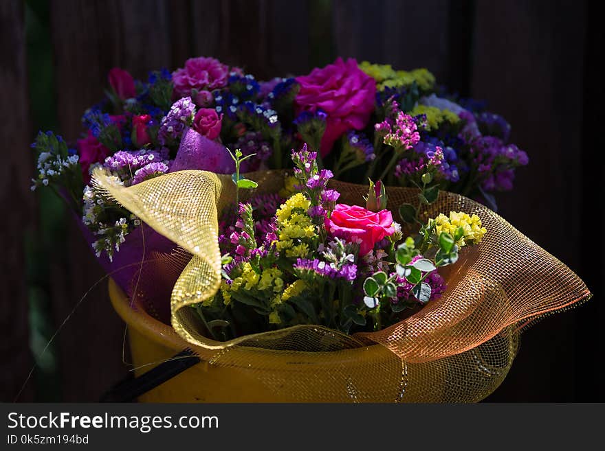 A bouquet of flowers in a bucket