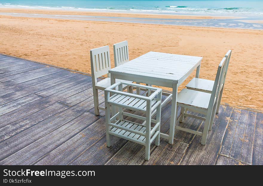 Wood floor and seaside table with beach and sea background.