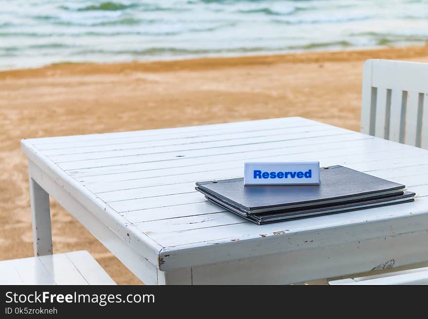 The seaside table with beach and sea background has reserved