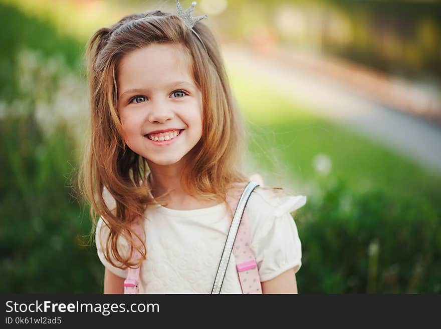 Portrait of cute little girl in summer park