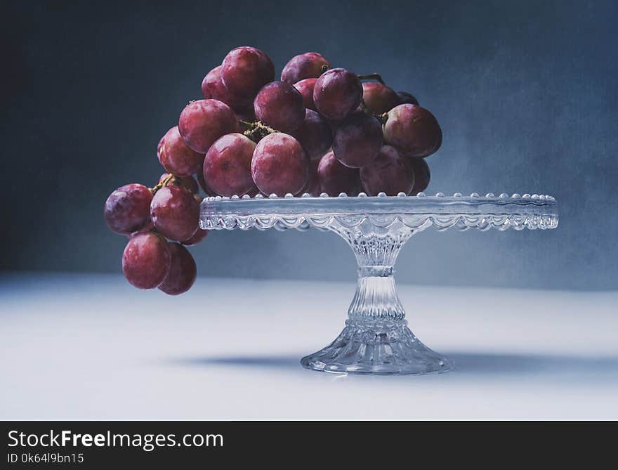 Red grapes with dark contrast and textured background