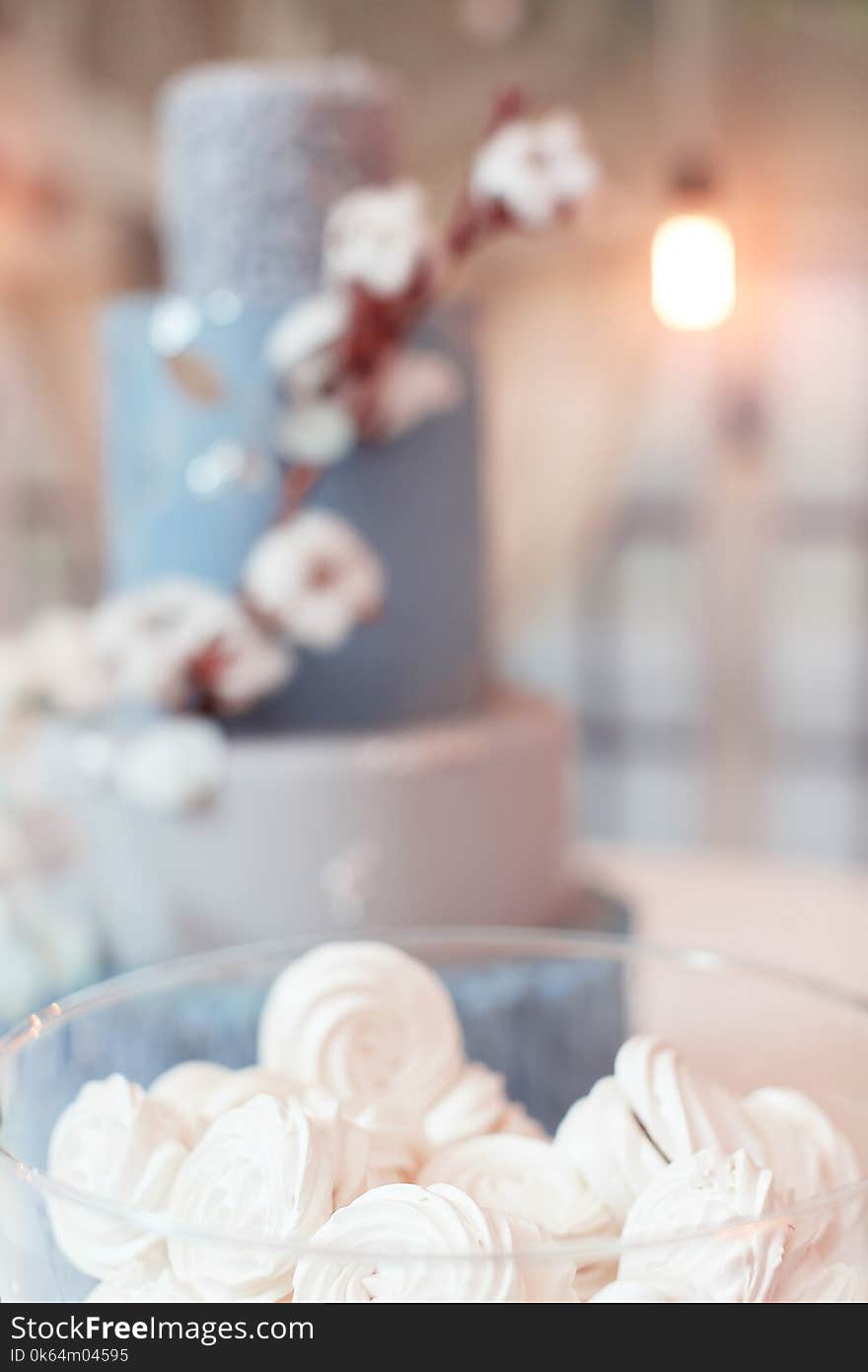 Cakes in a vase on the buffet.