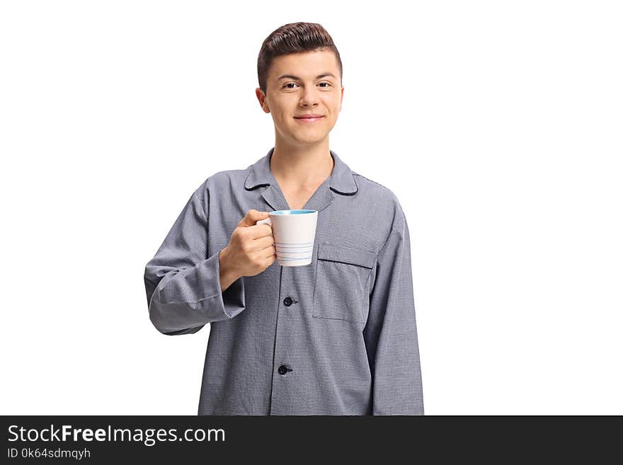 Teenage boy wearing pajamas and holding a cup isolated on white background