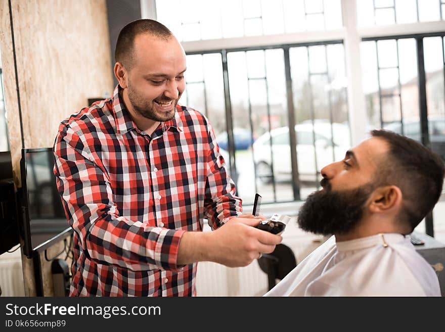 Barber Cutting A Beard With Scissors