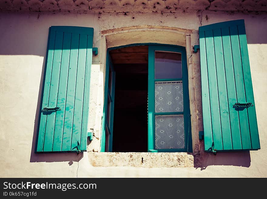 Colorful Shutters On Old Window