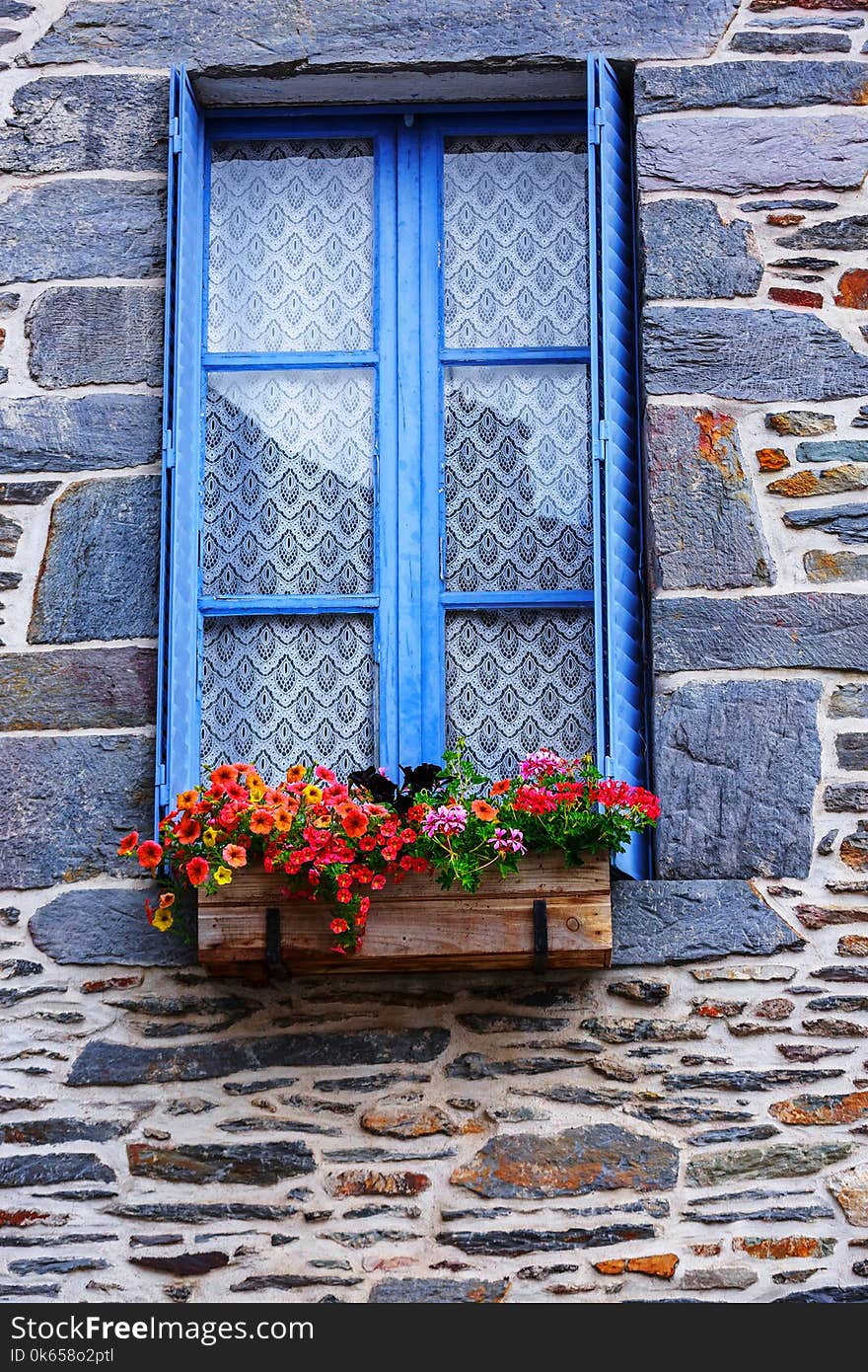 Flower Pot Placed At The Window Of Old House