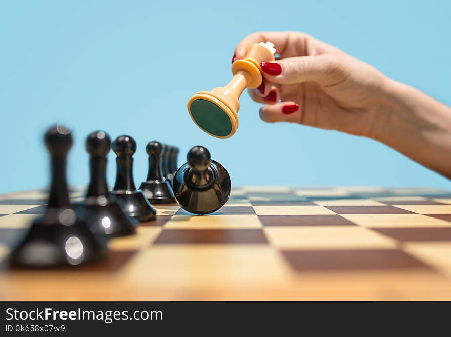 Ladies First. Chess board and game concept. Business ideas, competition, strategy and new ideas concept. Chess figures on blue background. Selective focus. Side view. Win, victory, winner concepts. Ladies First. Chess board and game concept. Business ideas, competition, strategy and new ideas concept. Chess figures on blue background. Selective focus. Side view. Win, victory, winner concepts