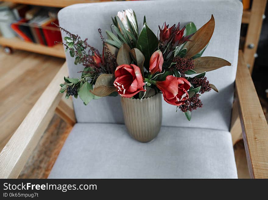 Red Tulip Flowers in Vase on Armchair