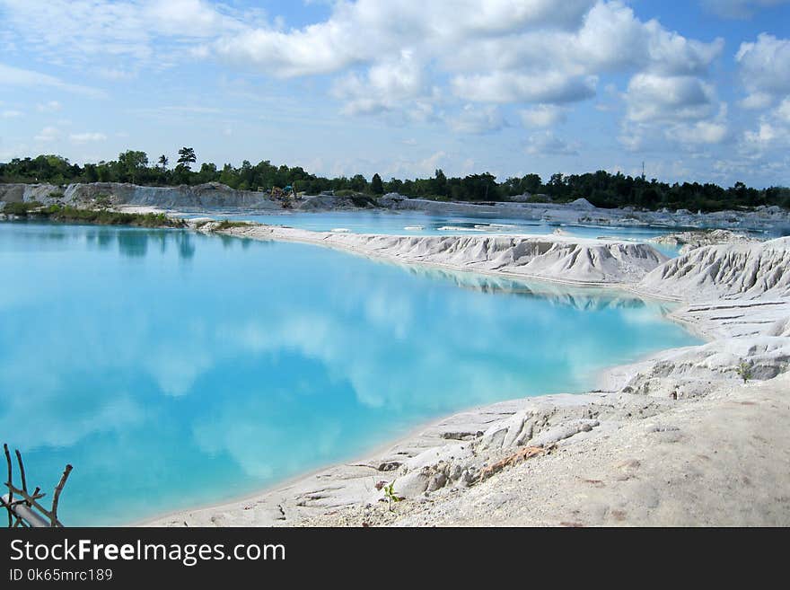 Landscape Photography of Body of Water Under Cloudy Sky