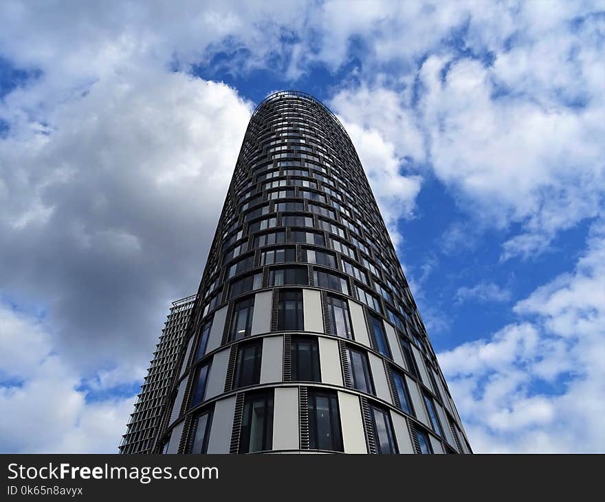 Gray Concrete Building during White Cloudy Skies