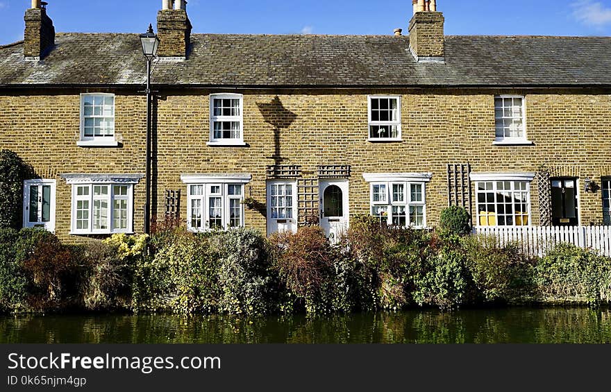 Yellow and White Bricked House