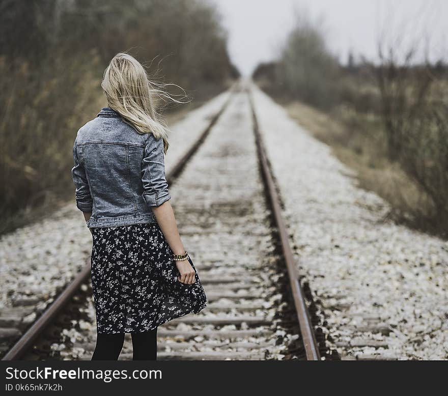 Woman Standing on Railroad