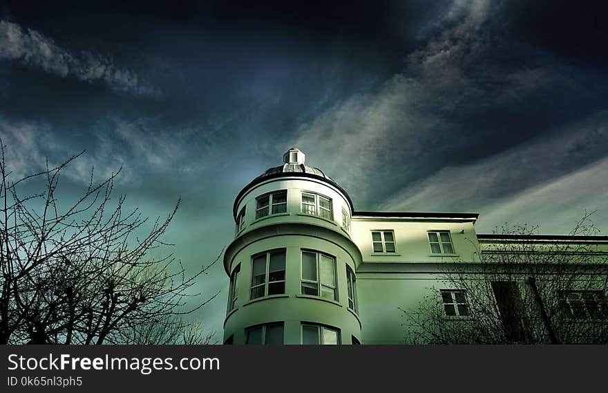 White Painted House Under Cloudy Sky