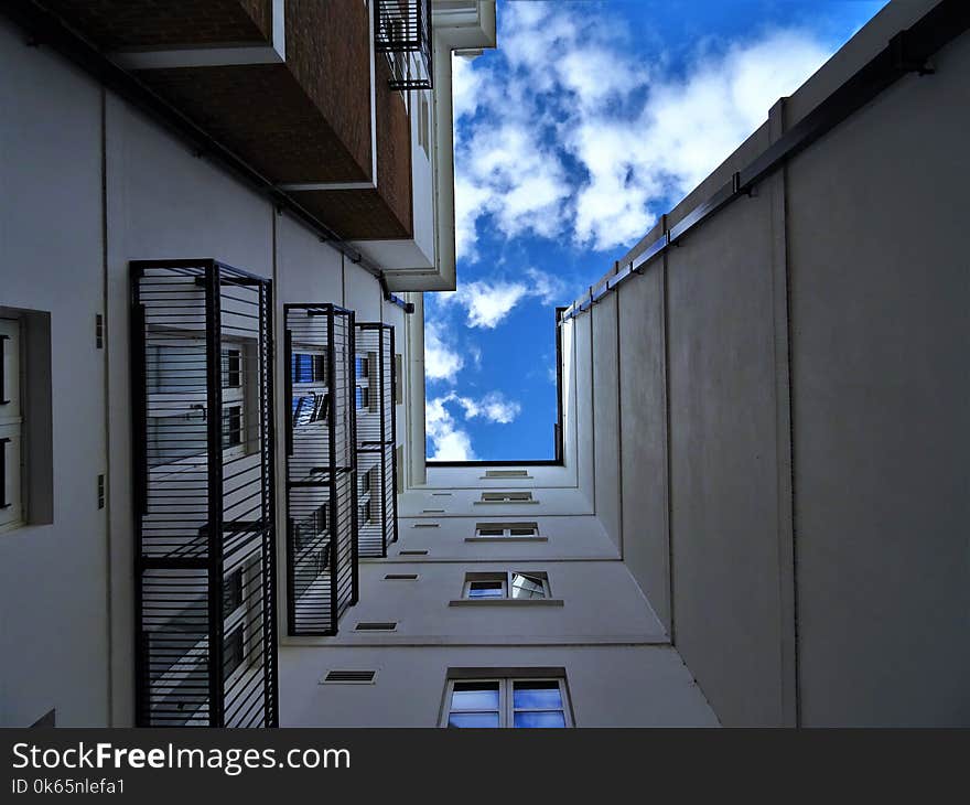 Low-angle Photography of Gray Concrete Building Under Blue Sky at Daytime