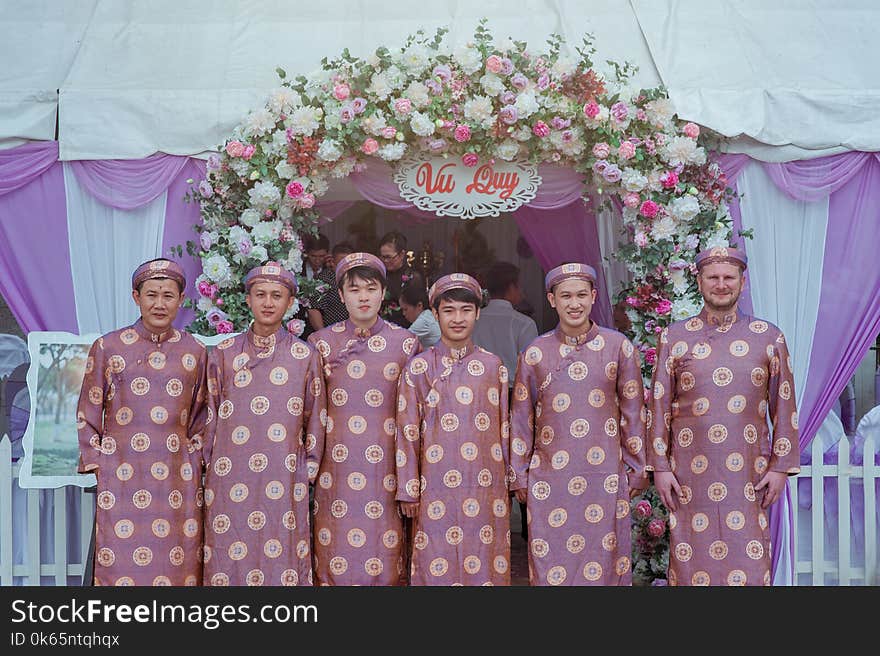 Group of Men Wearing Pink Robes