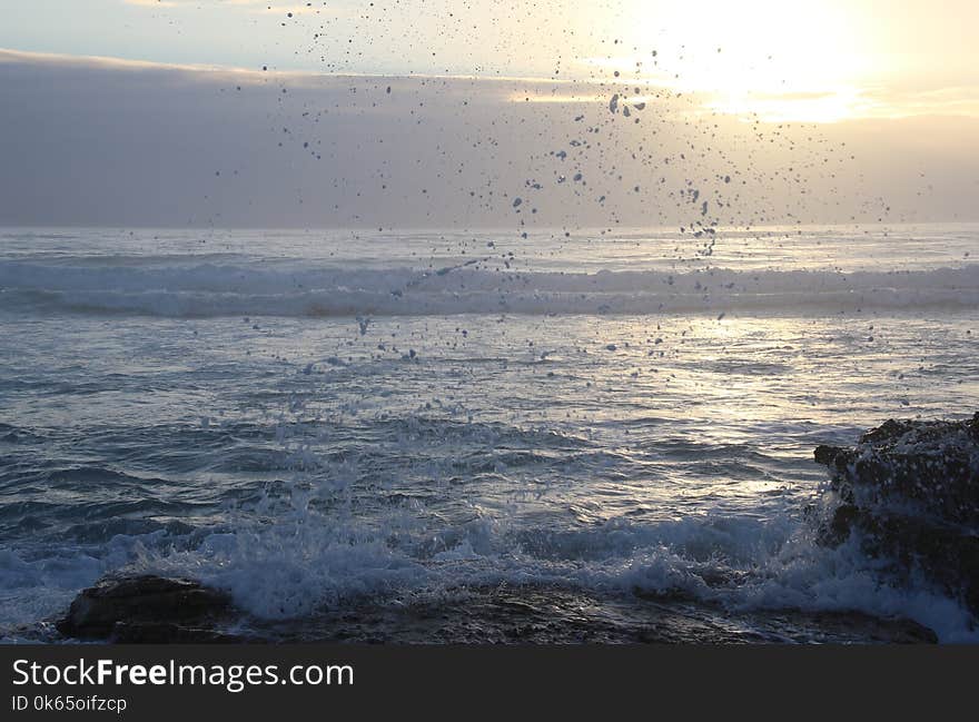 Ocean Waves Hammering Rock Boulder