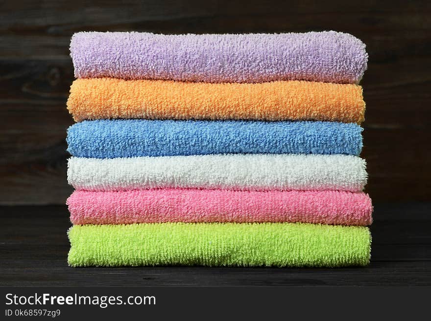 Bath towels on wooden background