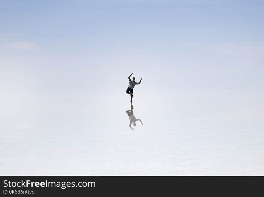 Young man in at Salar de uyuni salt flat in Bolivia