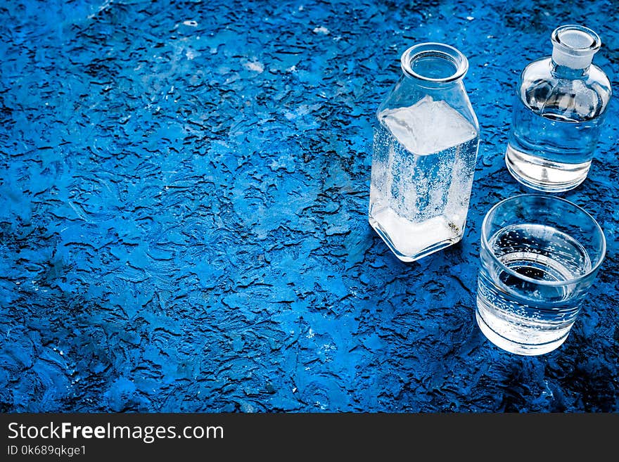 Drinks on the table. Pure water in jar and glasses on blue background space for text