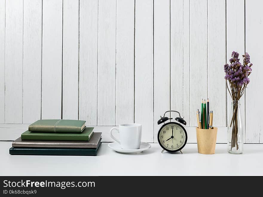 Education workspace background concepts Pencil, stationery, coffee cup, flowers, Book, alarm clock White wooden vintage wall. Education workspace background concepts Pencil, stationery, coffee cup, flowers, Book, alarm clock White wooden vintage wall