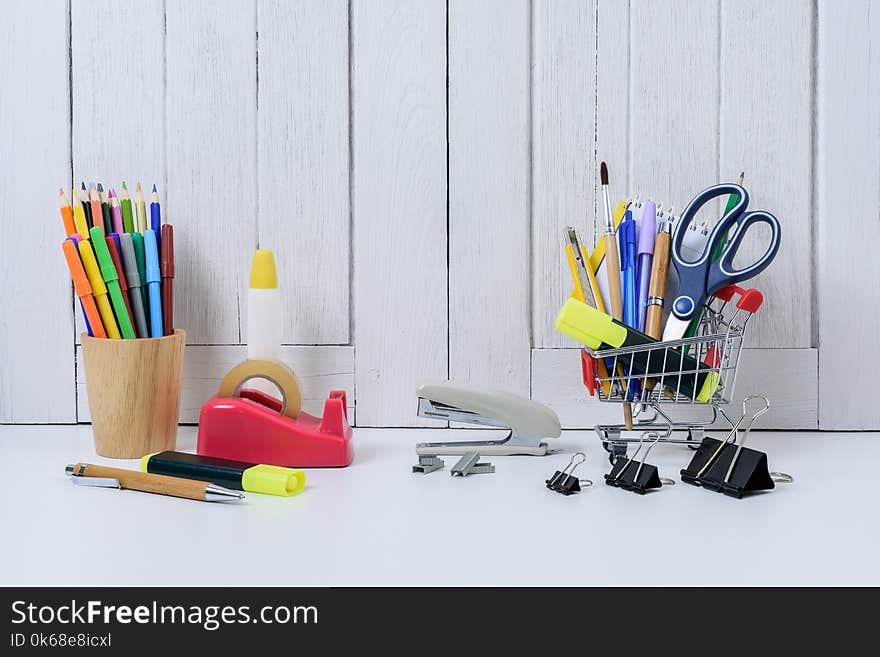 Education, Back to School, Shopping with shopping cart on table with White wooden vintage wall