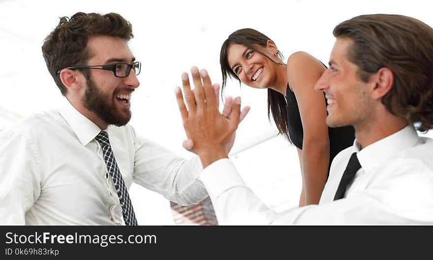 Business colleagues giving each other high five.