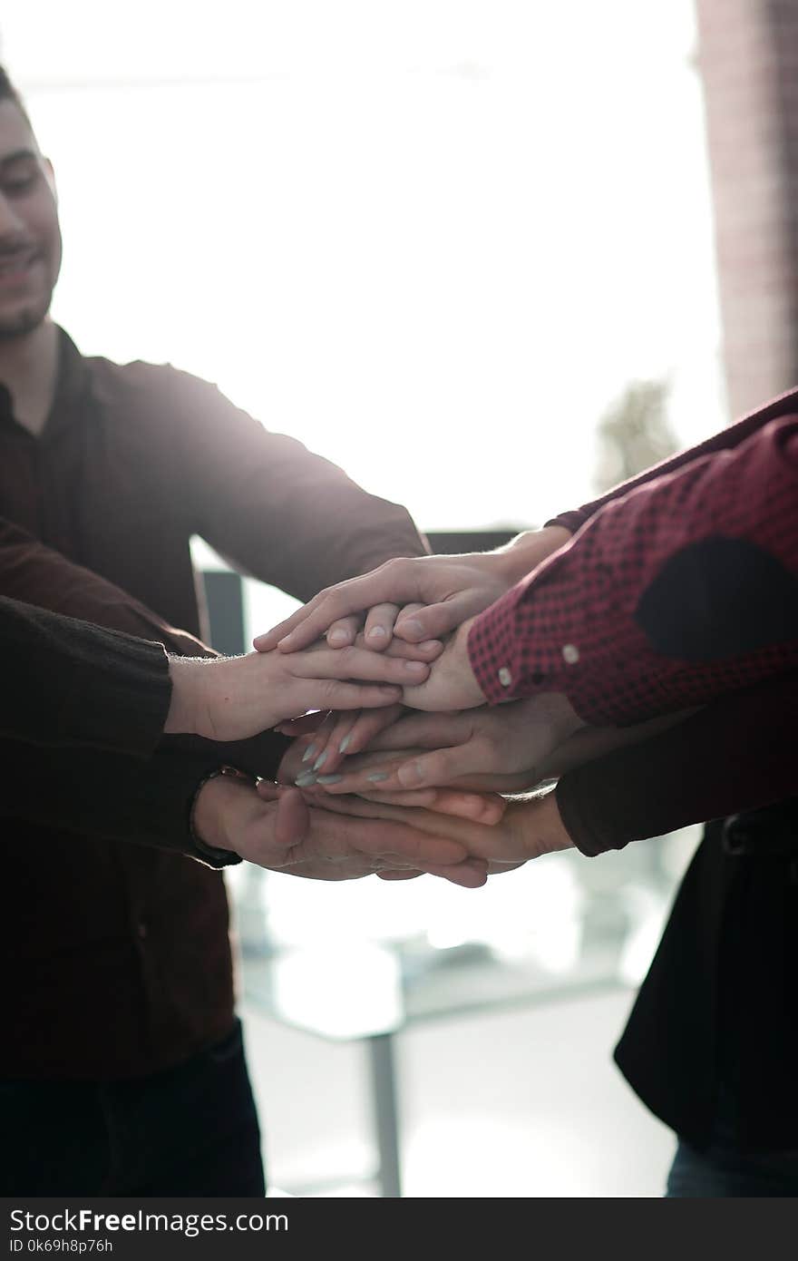 Successful business team with hands clasped together.