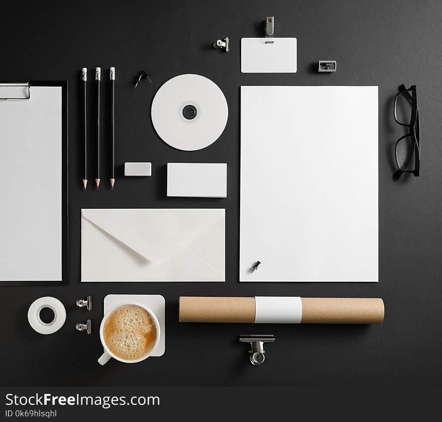 Blank stationery set on black paper background. Template for branding identity. For graphic designers presentations and portfolios. Top view. Flat lay.